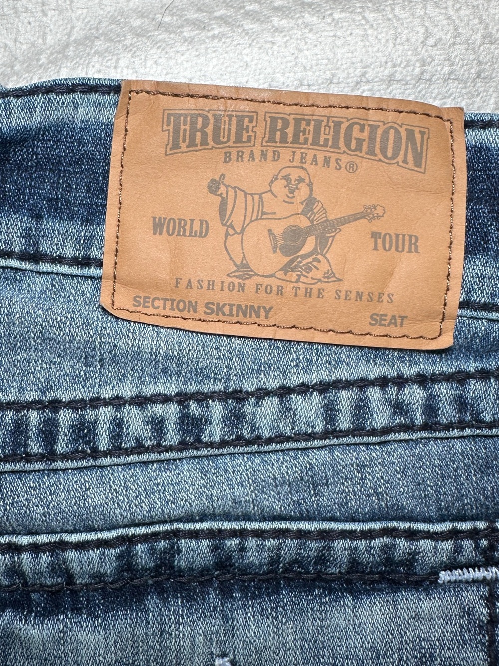 True Religion Men’s Skinny Jeans in Medium Blue Wash with Brown Leather Patch